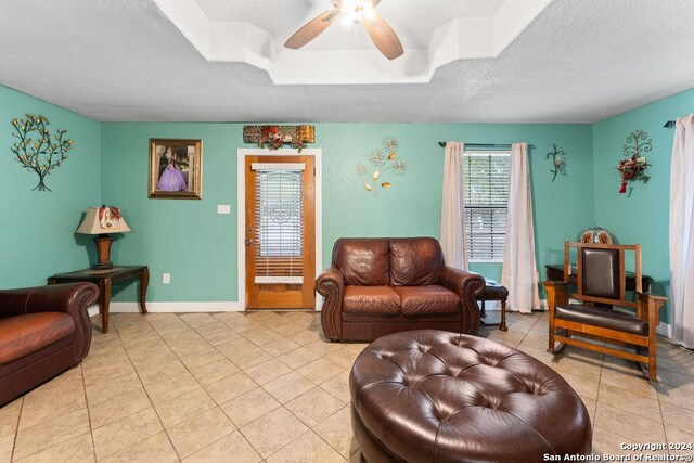 22620 Little Walnut Dr, San Antonio, TX 78264 - living area with ceiling fan, light tile patterned flooring, a textured ceiling, and baseboards