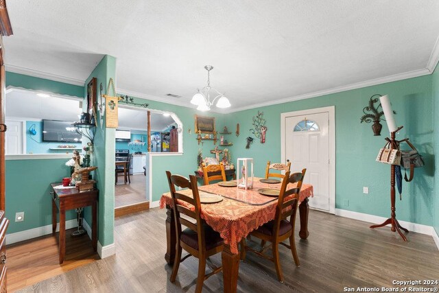 22620 Little Walnut Dr, San Antonio, TX 78264 - dining room featuring a chandelier, wood finished floors, ornamental molding, and baseboards