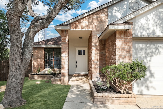 property entrance with a yard and a garage