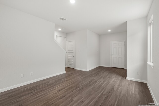 unfurnished room with dark hardwood / wood-style flooring