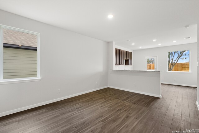 empty room with dark hardwood / wood-style flooring