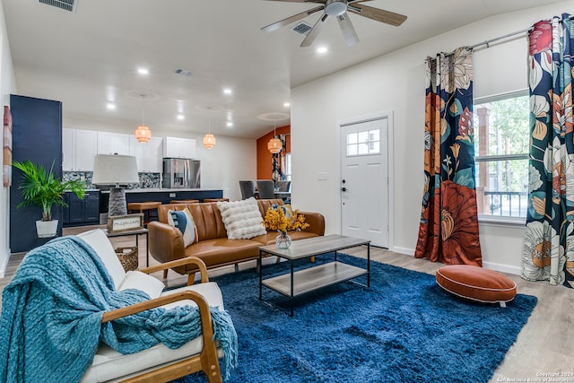 living room featuring ceiling fan and hardwood / wood-style flooring