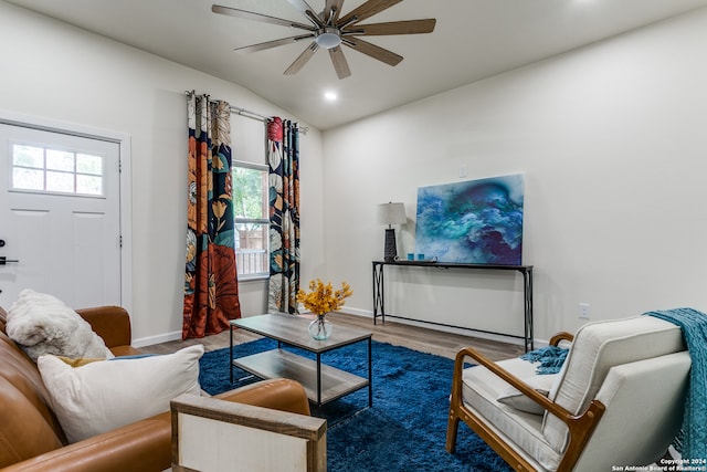 living room featuring hardwood / wood-style flooring, plenty of natural light, lofted ceiling, and ceiling fan