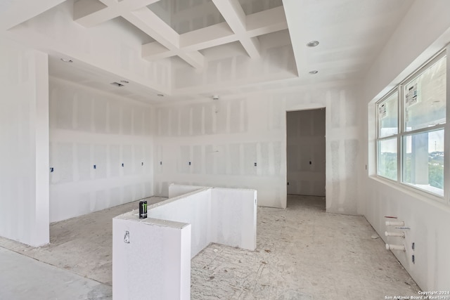 interior space with coffered ceiling and beam ceiling