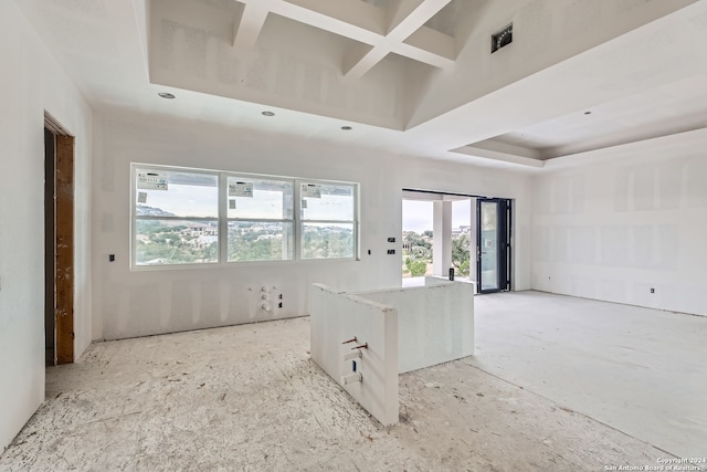 unfurnished room with a wealth of natural light, french doors, and coffered ceiling