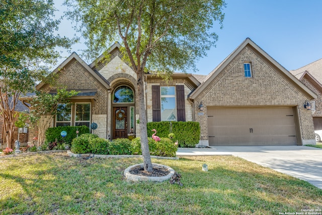 view of front of house featuring a front yard and a garage