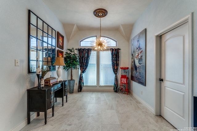 interior space featuring a chandelier, vaulted ceiling, and a wealth of natural light