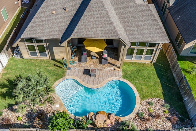 view of swimming pool featuring a yard and a patio