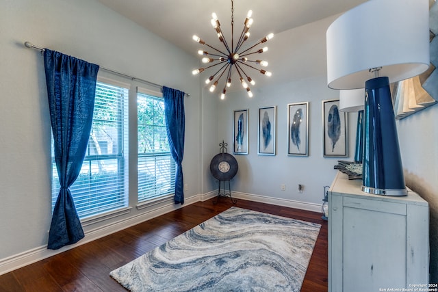 interior space with a chandelier and dark hardwood / wood-style floors