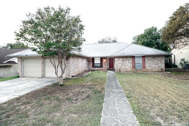 ranch-style home with a garage and a front lawn