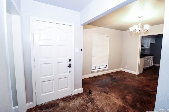 foyer entrance with a chandelier