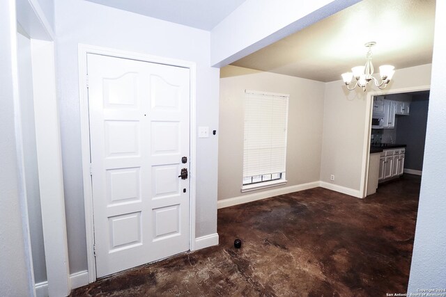 7227 Trace Buckle, San Antonio, TX 78240 - foyer entrance with concrete flooring, a chandelier, and baseboards