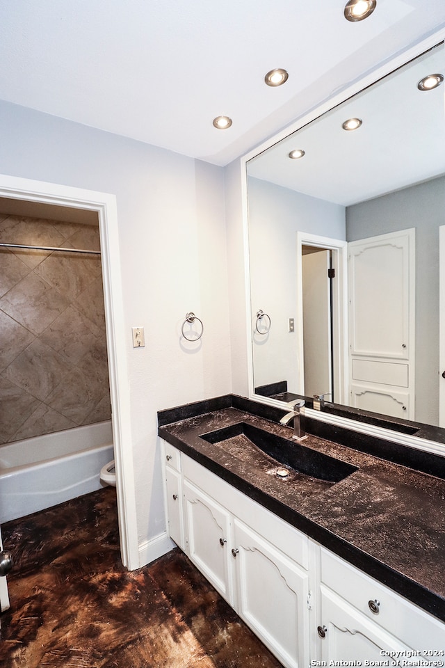 full bathroom featuring vanity, toilet, and tiled shower / bath combo