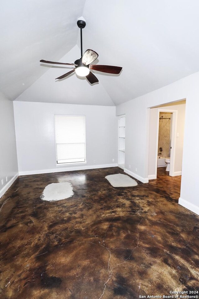 7227 Trace Buckle, San Antonio, TX 78240 - empty room featuring a ceiling fan, vaulted ceiling, baseboards, and concrete floors