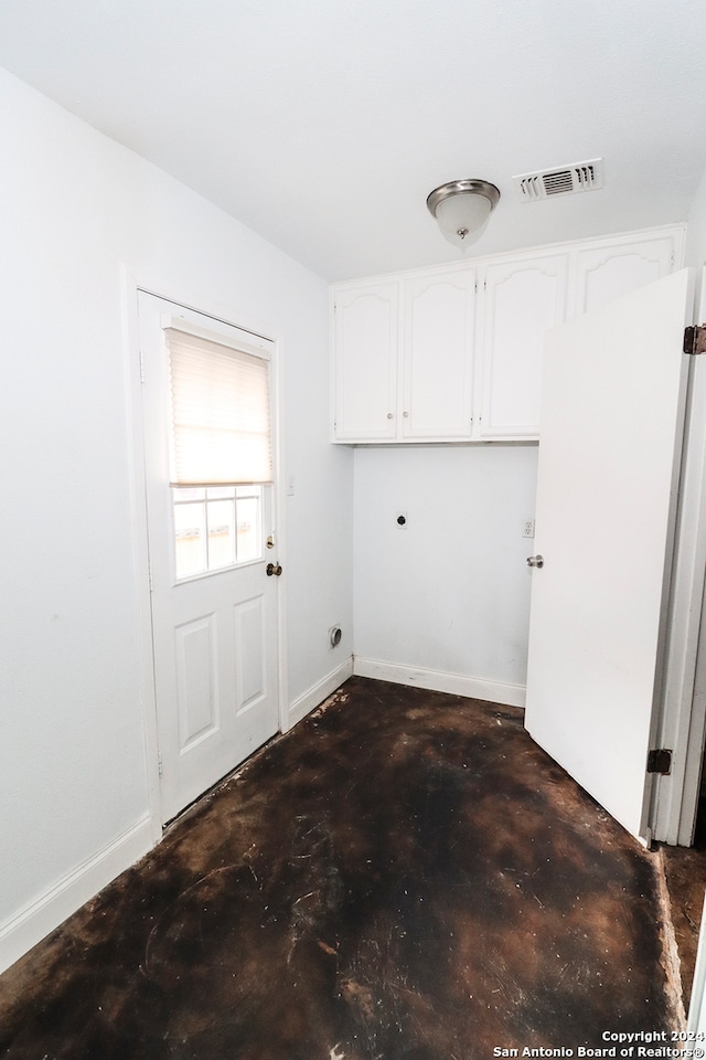 laundry room featuring cabinets and electric dryer hookup