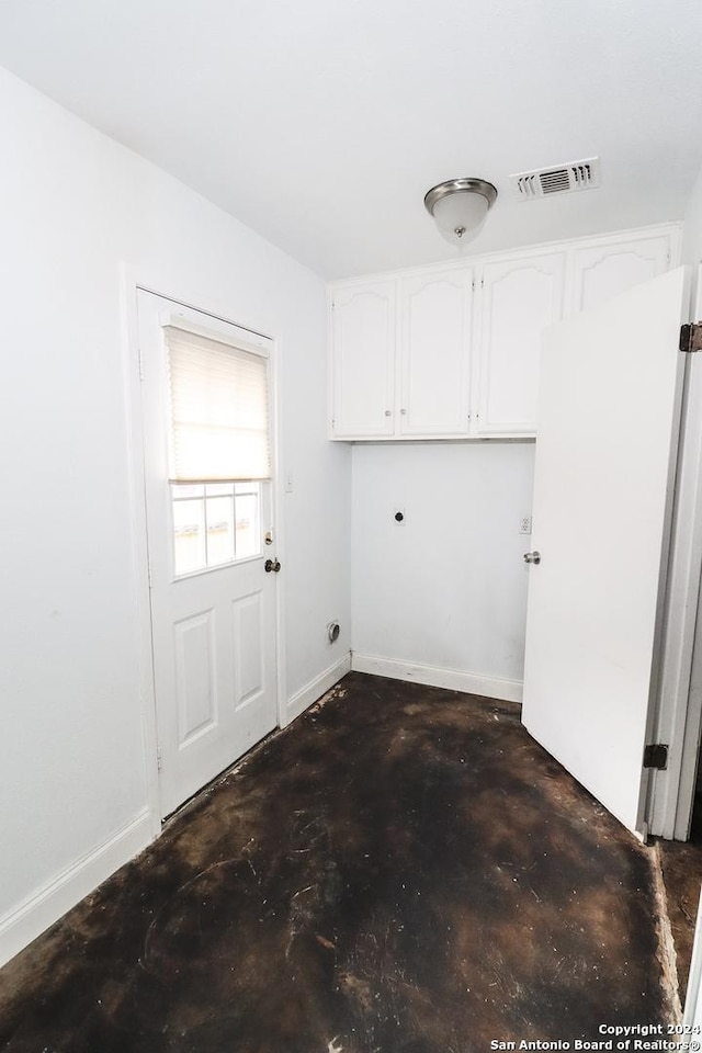 7227 Trace Buckle, San Antonio, TX 78240 - clothes washing area featuring cabinet space, electric dryer hookup, and baseboards