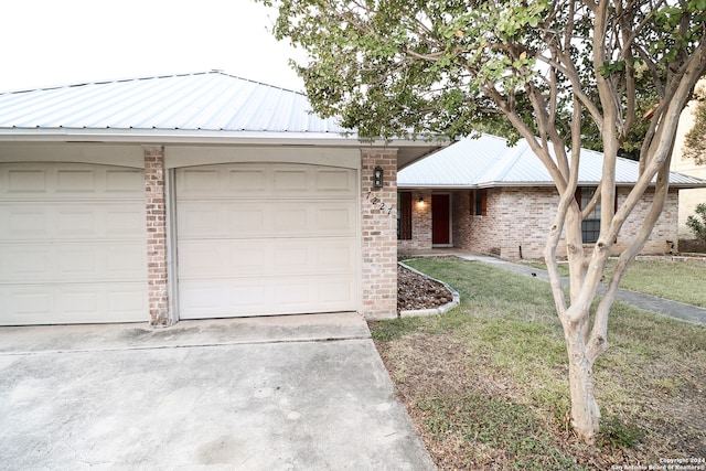 ranch-style house with a front yard and a garage