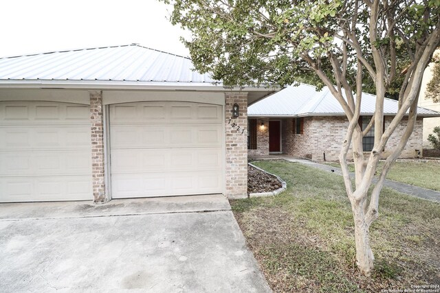 7227 Trace Buckle, San Antonio, TX 78240 - ranch-style home featuring metal roof, brick siding, a front lawn, and driveway
