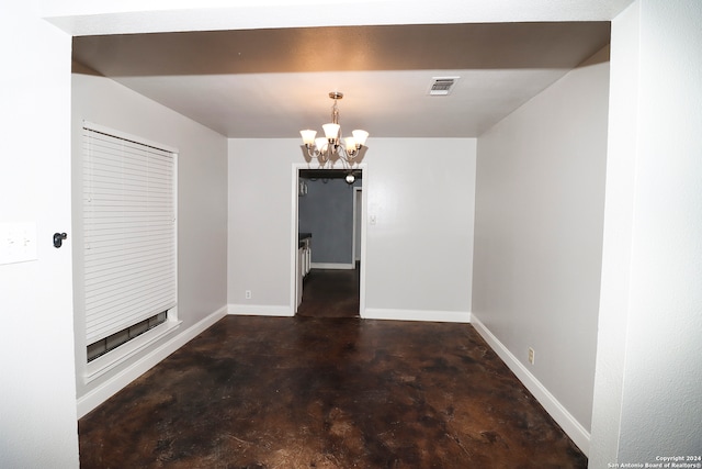 unfurnished dining area featuring an inviting chandelier