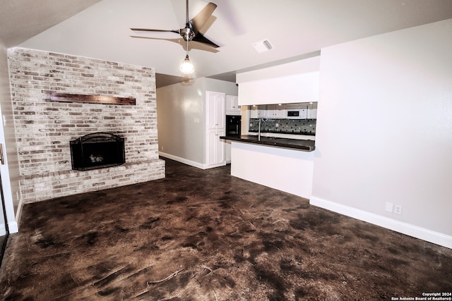 unfurnished living room with a fireplace and ceiling fan