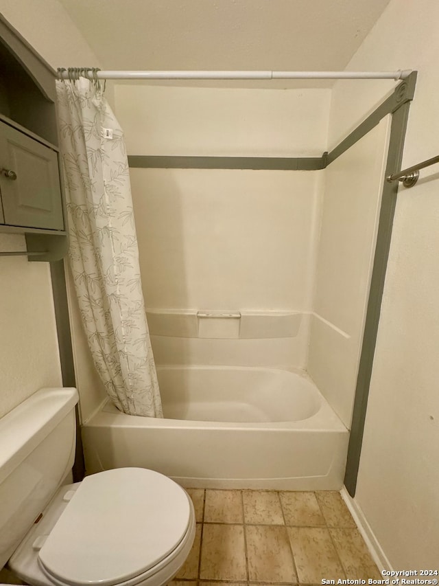 bathroom with shower / tub combo and toilet