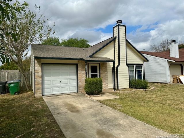 single story home featuring a front lawn and a garage