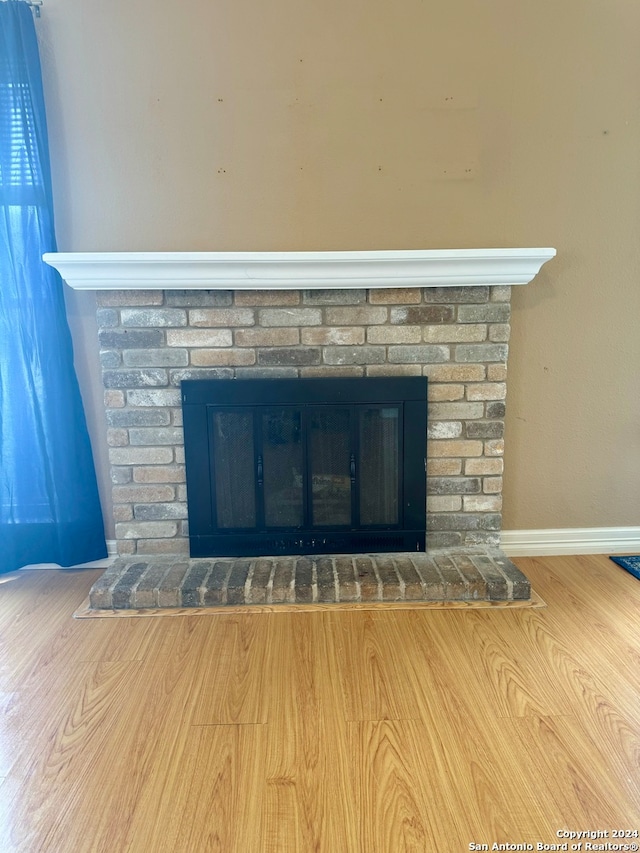 interior details with a fireplace and wood-type flooring