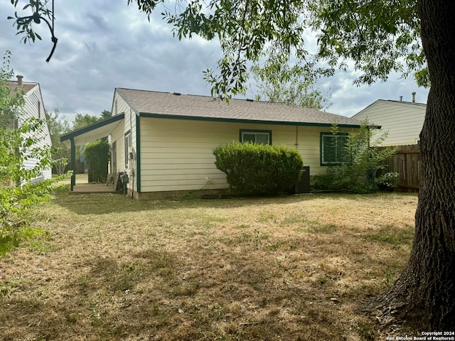 rear view of house with a yard