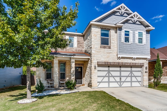 craftsman-style house with a front yard, a garage, and a porch