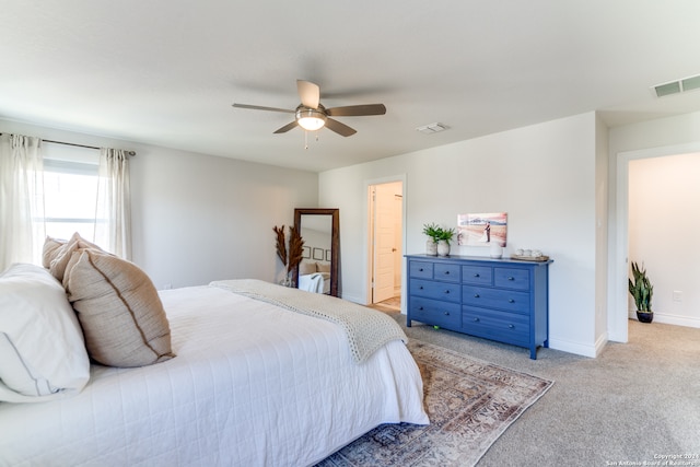 bedroom with ceiling fan and light carpet