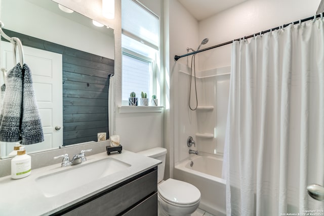 full bathroom featuring toilet, vanity, shower / bath combo, and plenty of natural light