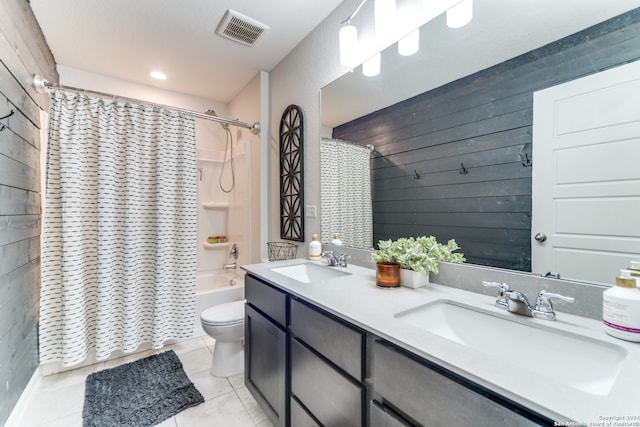 full bathroom with toilet, wooden walls, shower / bath combination with curtain, tile patterned floors, and vanity