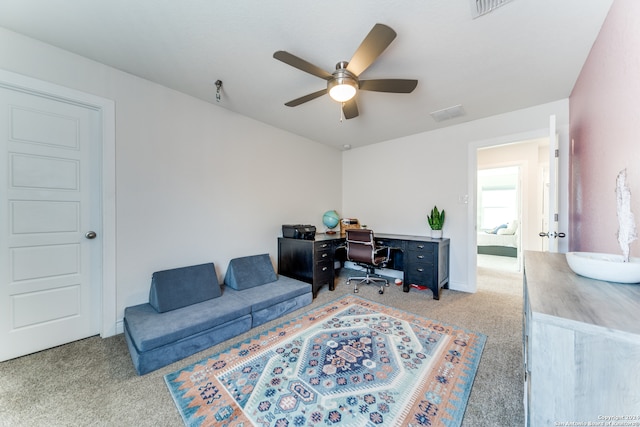 office featuring ceiling fan and light carpet