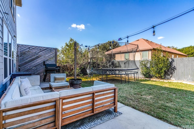 view of patio / terrace featuring a trampoline and an outdoor living space