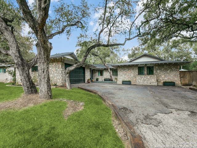 ranch-style home with a front yard and a garage