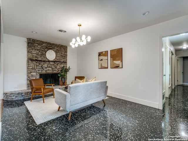 living room featuring a stone fireplace and a chandelier