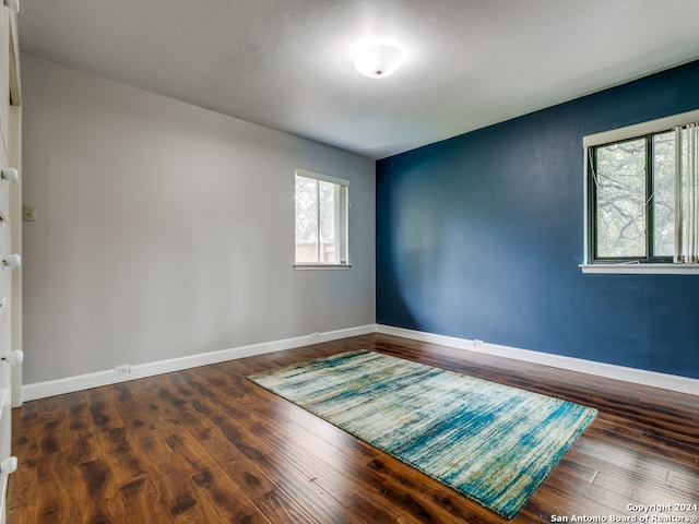 empty room with dark wood-type flooring