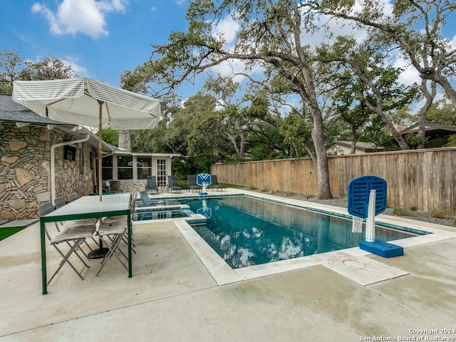 view of swimming pool featuring a patio area