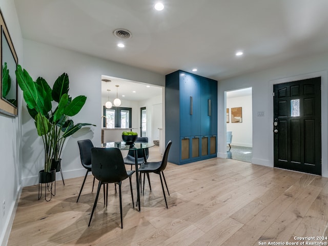 dining space with light hardwood / wood-style flooring