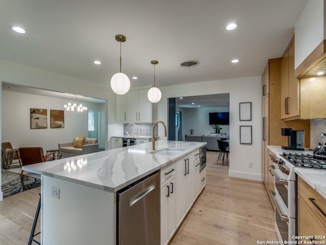 kitchen with white cabinetry, white range with gas cooktop, sink, and light hardwood / wood-style floors