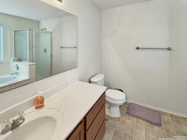 bathroom featuring vanity, toilet, and a shower with shower door