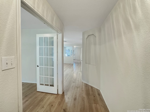 hall with light hardwood / wood-style flooring