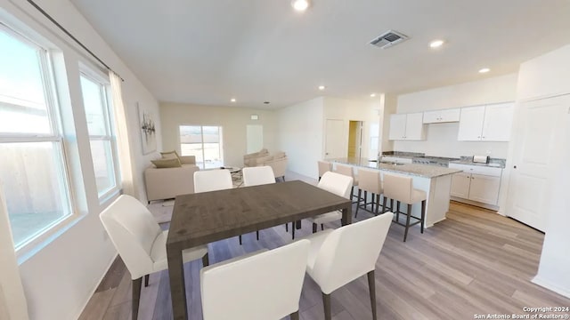 dining space with light wood-type flooring