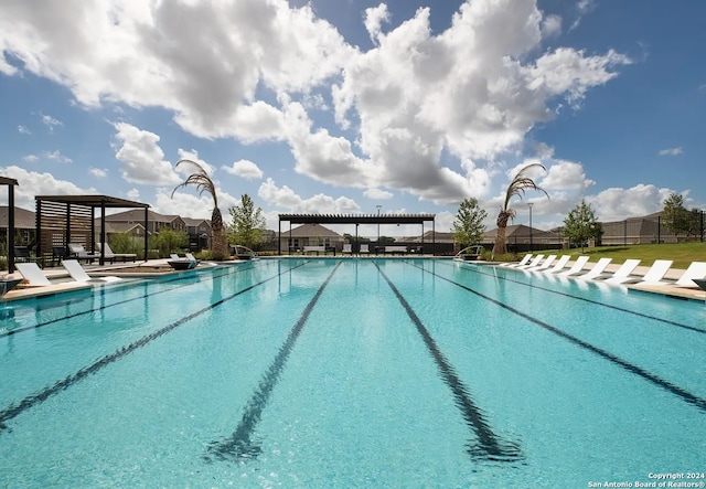 view of pool with a pergola and a patio