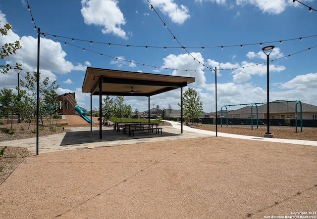 view of home's community with a playground and a patio area