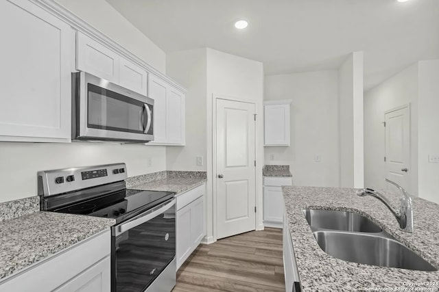 kitchen with white cabinetry, sink, and stainless steel appliances