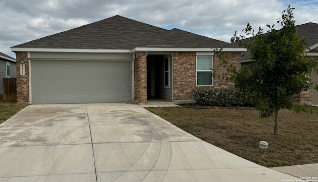 view of front of house with a front yard and a garage