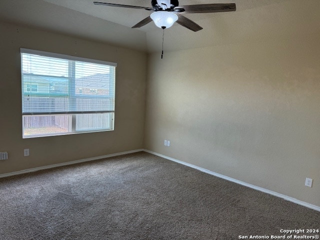 carpeted empty room featuring ceiling fan and a healthy amount of sunlight