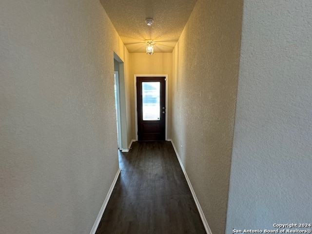 corridor featuring dark wood-type flooring