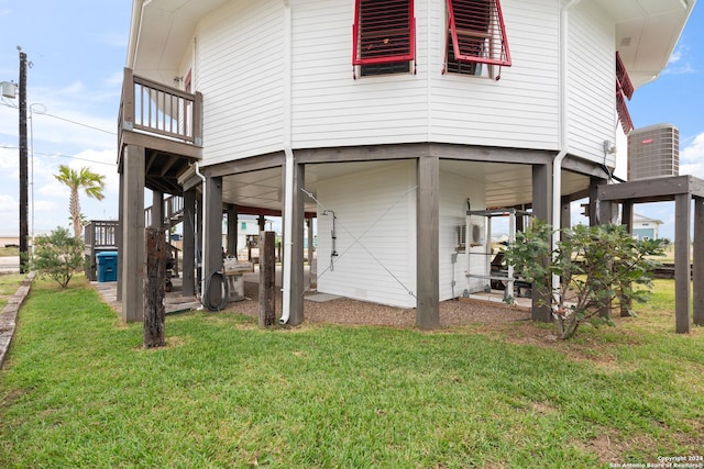 1517 S Magnolia St, Rockport, TX 78382 - rear view of property with a lawn and central AC unit